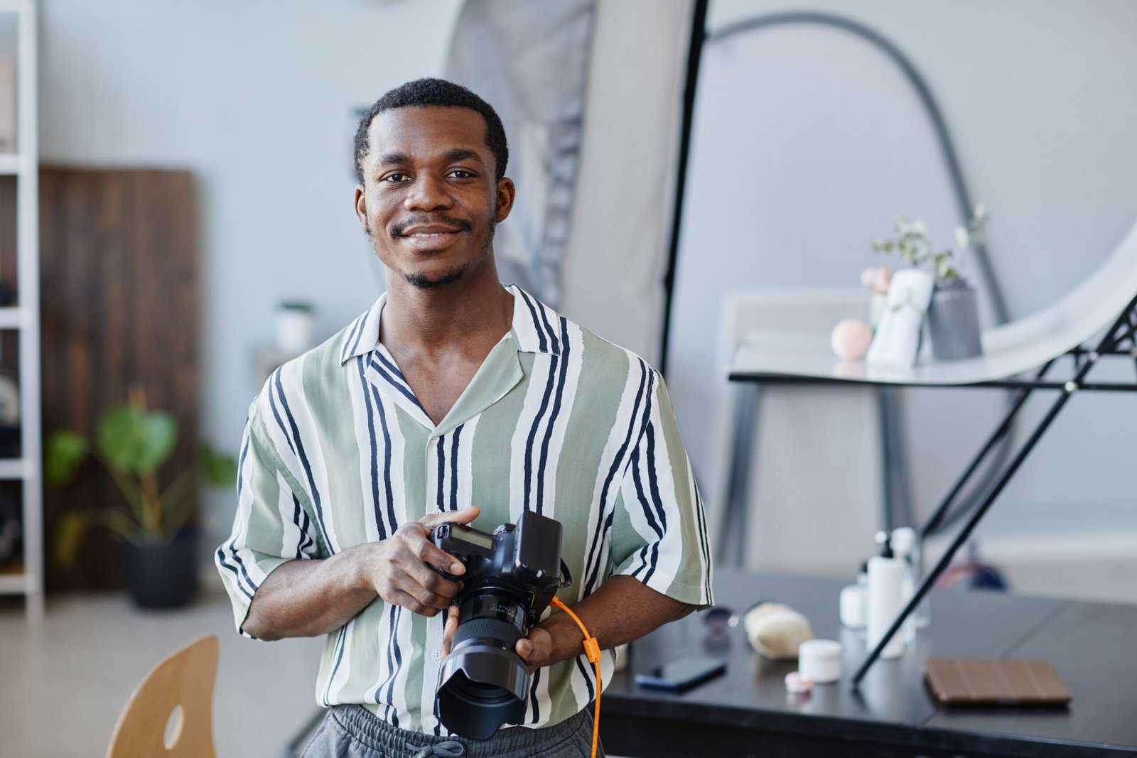 portrait-of-black-young-man-with-photo-camera-2023-11-27-04-59-24-utc-scaled.jpg